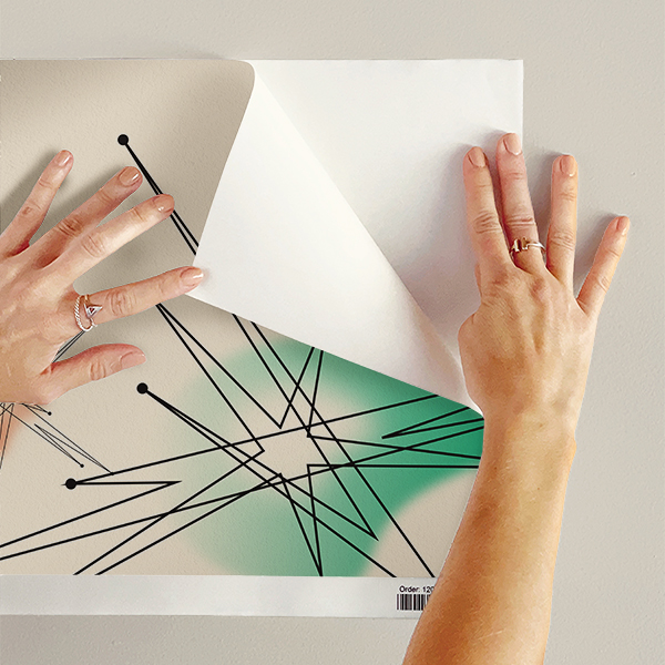 The artwork features a repeating geometric pattern of symmetrical shapes resembling elongated, curved diamonds or petals in various shades of blue and green. Each shape is split vertically with one half filled with a light blue and the other half filled with green or darker blue. The background is a light, almost pastel blue, which provides a soft yet vibrant backdrop. One of the blue shapes near the upper left contains a white starburst element, adding a focal point of brightness to the composition. The overall design conveys a modern, mid-century aesthetic with clean lines and harmonious color contrasts.